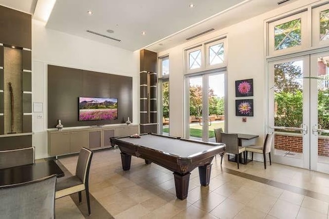 recreation room with a towering ceiling, pool table, french doors, and light tile patterned flooring