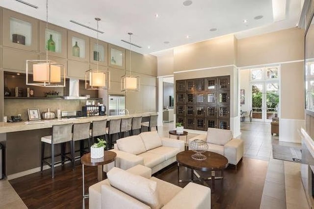 living room with a high ceiling and french doors