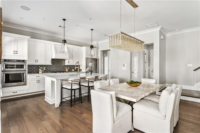 dining room featuring crown molding, visible vents, dark wood finished floors, and stairway