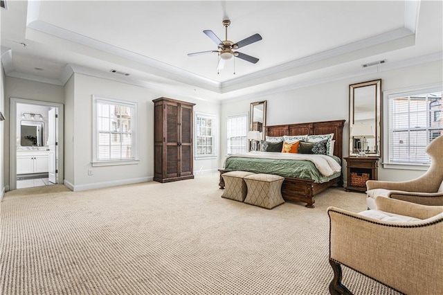 bedroom featuring baseboards, visible vents, a raised ceiling, and light colored carpet