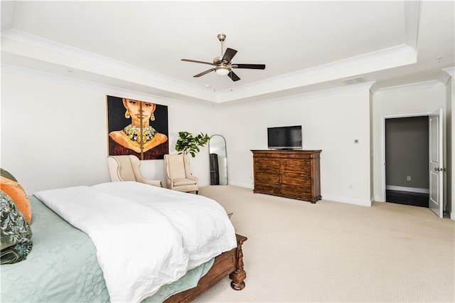 bedroom with a raised ceiling, light carpet, crown molding, and baseboards