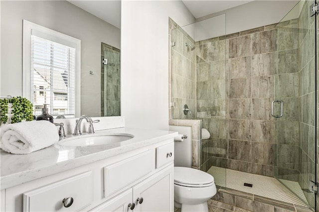 full bath with toilet, a shower stall, and vanity