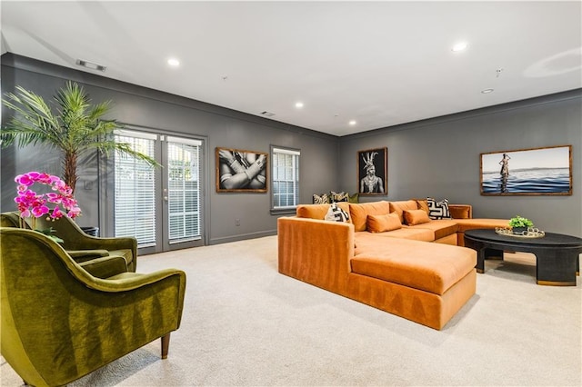 carpeted living area with recessed lighting, visible vents, and baseboards