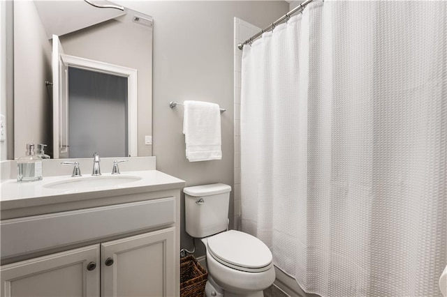 full bathroom with toilet, curtained shower, and vanity