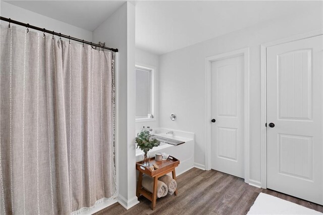 bathroom featuring baseboards and wood finished floors