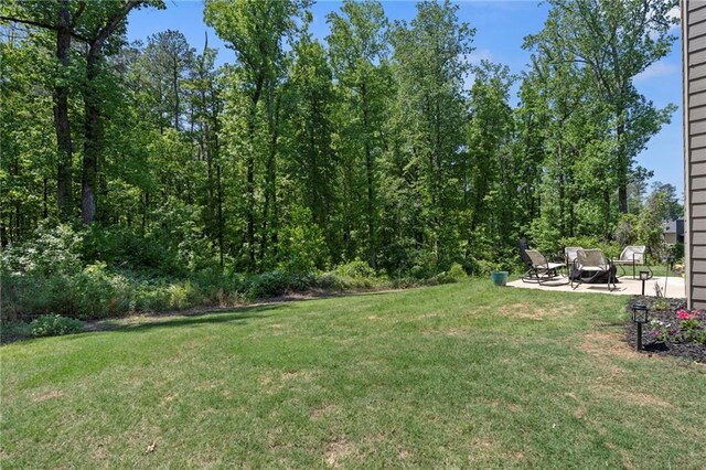 view of yard with a patio area and a fire pit