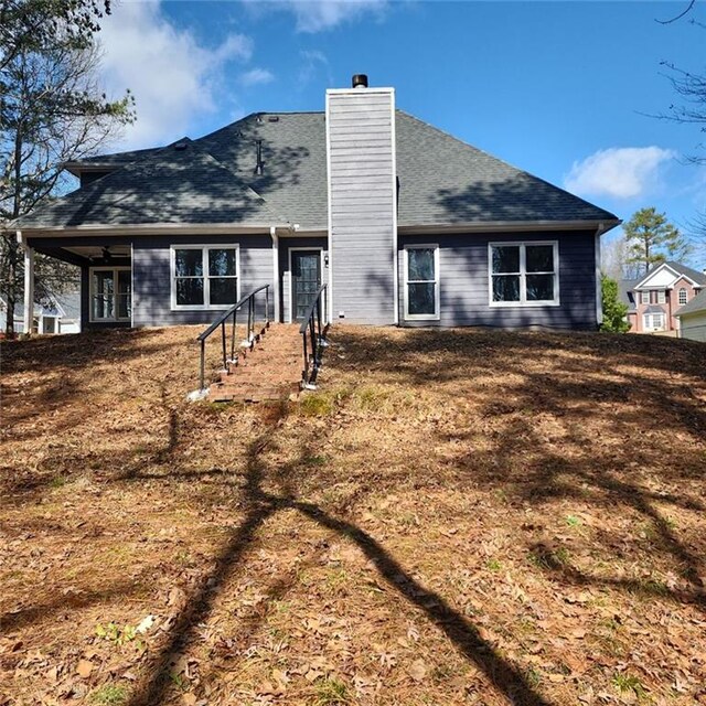 20 Wisteria Blvd, Covington, GA 30016 - rear view of property featuring french doors, a chimney, and roof with shingles
