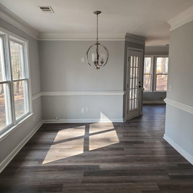 unfurnished dining area featuring crown molding, a chandelier, and dark hardwood / wood-style flooring