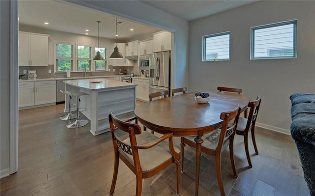 6003 Rollingwood Way, Hoschton, GA 30548 - dining area with healthy amount of natural light, dark wood-style floors, and recessed lighting