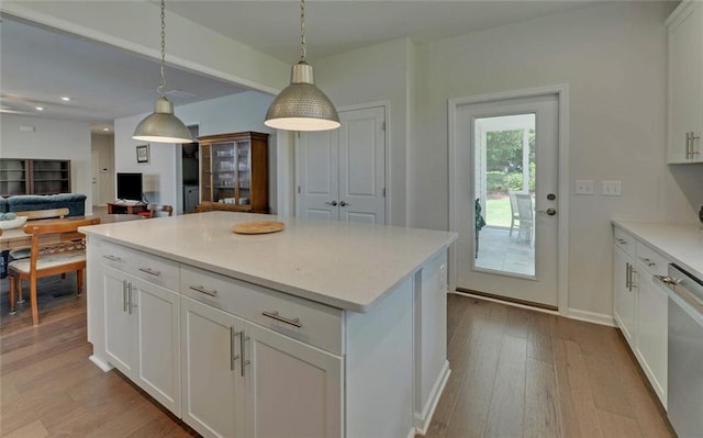 6003 Rollingwood Way, Hoschton, GA 30548 - kitchen with light wood-style flooring, white cabinets, decorative light fixtures, and recessed lighting