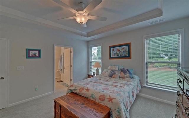 6003 Rollingwood Way, Hoschton, GA 30548 - bedroom featuring light colored carpet, a raised ceiling, ceiling fan, and connected bathroom