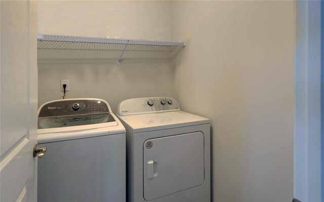 6003 Rollingwood Way, Hoschton, GA 30548 - laundry area with washing machine and dryer