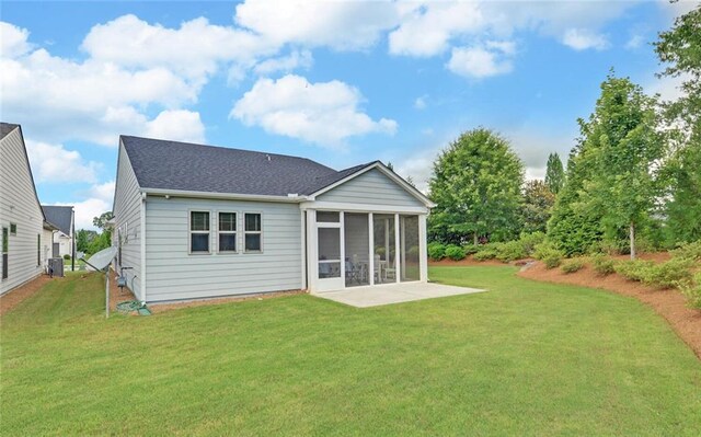 6003 Rollingwood Way, Hoschton, GA 30548 - back of house featuring a sunroom, a yard, a patio area, and a shingled roof
