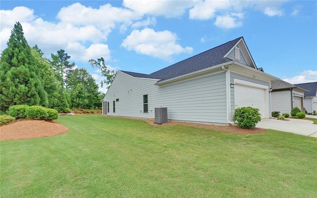 6003 Rollingwood Way, Hoschton, GA 30548 - view of side of home with driveway, an attached garage, a lawn, and roof with shingles