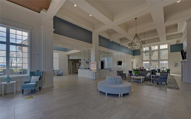 6003 Rollingwood Way, Hoschton, GA 30548 - common area featuring a towering ceiling, a decorative wall, beamed ceiling, coffered ceiling, and recessed lighting