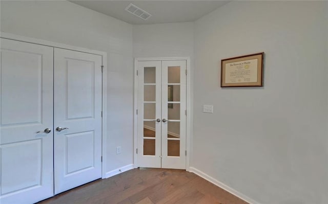 6003 Rollingwood Way, Hoschton, GA 30548 - unfurnished bedroom with french doors, wood finished floors, and a closet