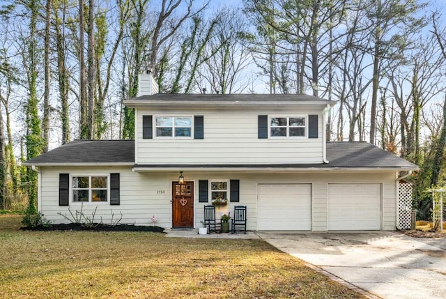 view of front property featuring a front yard and a garage