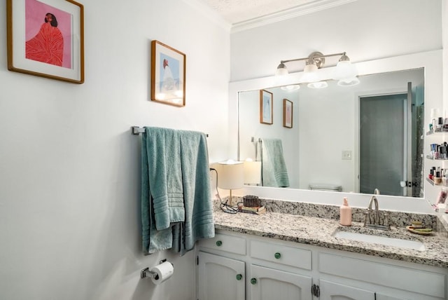 bathroom featuring crown molding, vanity, and toilet