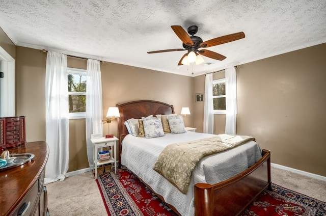 carpeted bedroom with ornamental molding, a textured ceiling, and ceiling fan