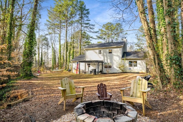 back of property featuring a pergola and an outdoor fire pit