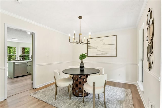 5759 Albans Way, Lithonia, GA 30058 - dining room featuring light wood-type flooring, a chandelier, ornamental molding, and baseboards