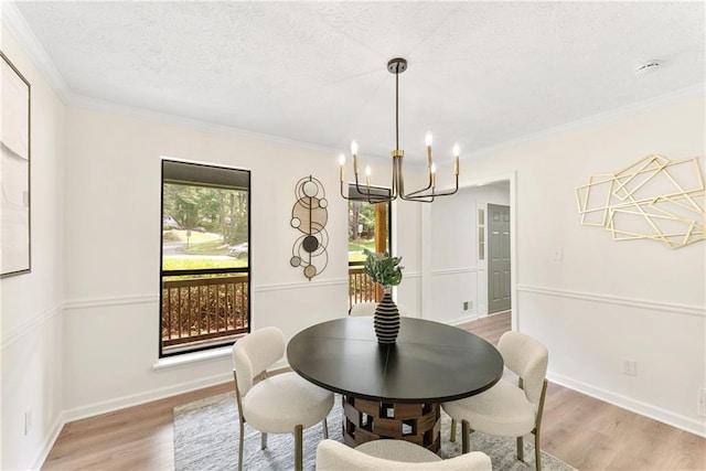 5759 Albans Way, Lithonia, GA 30058 - dining area featuring a chandelier, light wood-style flooring, crown molding, a textured ceiling, and baseboards