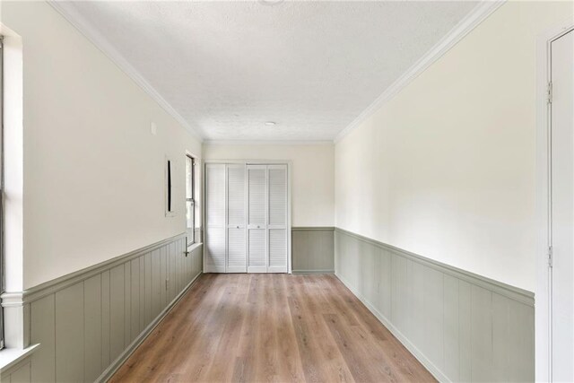 5759 Albans Way, Lithonia, GA 30058 - unfurnished room featuring a wainscoted wall, light wood finished floors, and crown molding