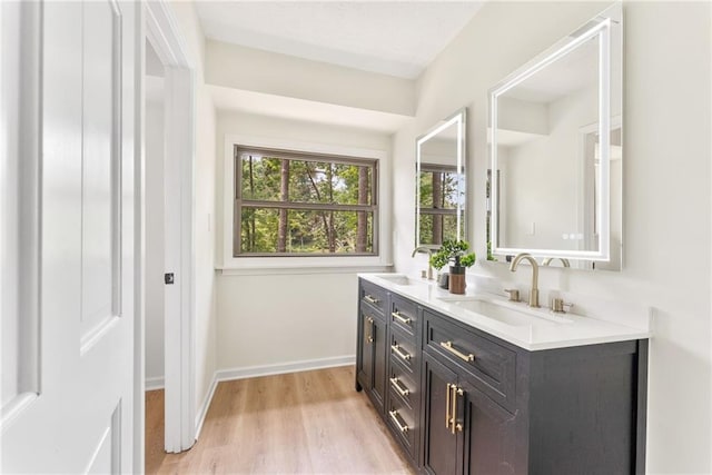 5759 Albans Way, Lithonia, GA 30058 - bathroom featuring double vanity, wood finished floors, and baseboards