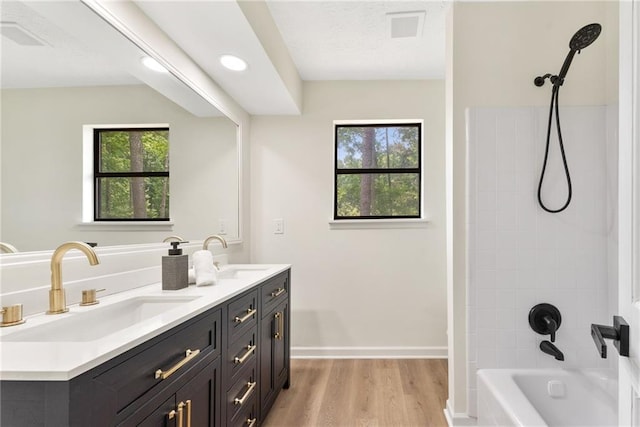 5759 Albans Way, Lithonia, GA 30058 - bathroom with double vanity, shower / bath combination, wood finished floors, baseboards, and recessed lighting