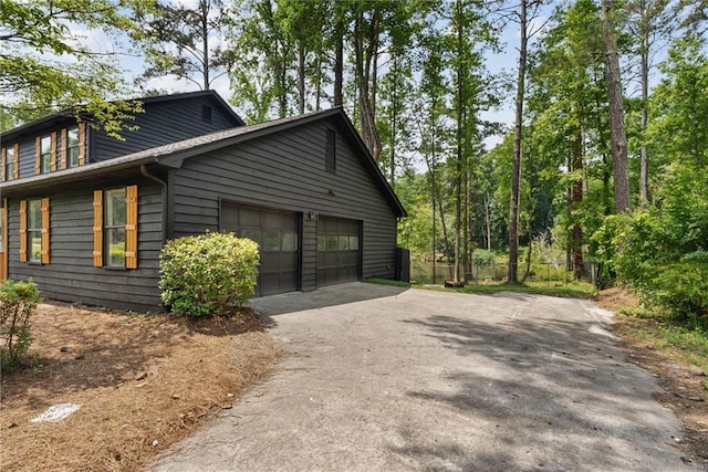 5759 Albans Way, Lithonia, GA 30058 - view of side of property with asphalt driveway and a garage