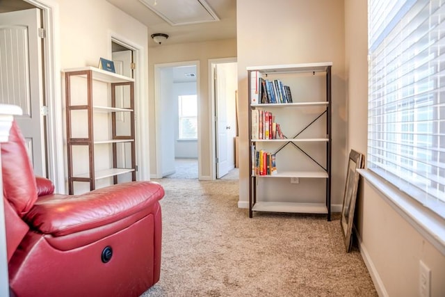 living area featuring light carpet