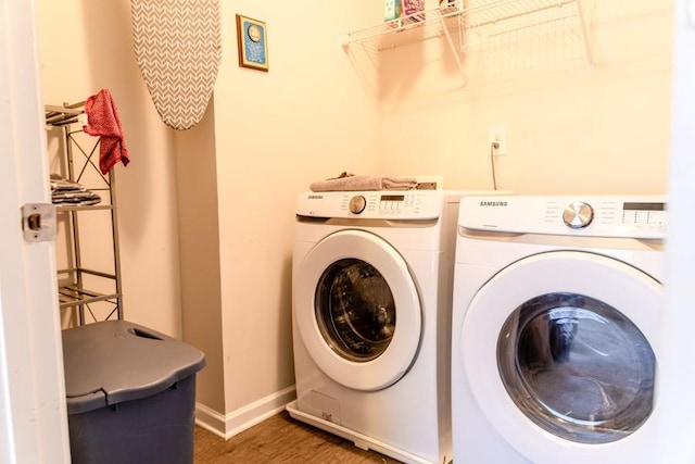 laundry area with independent washer and dryer and dark wood-type flooring