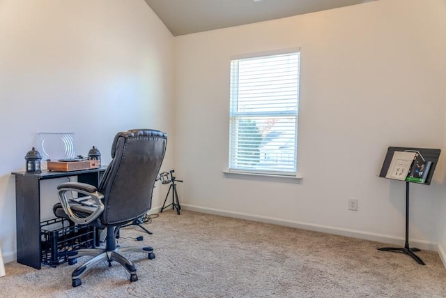 office space with lofted ceiling and light carpet