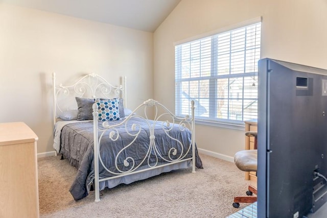 bedroom with carpet floors, vaulted ceiling, and multiple windows