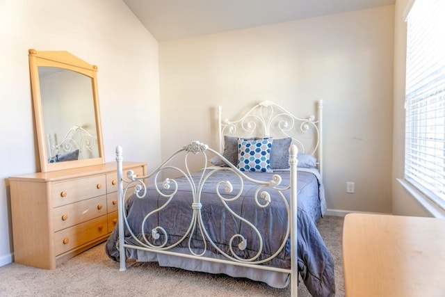 bedroom featuring carpet floors and vaulted ceiling