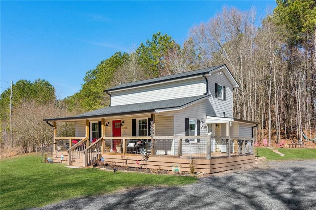 view of front of home with a porch and a front yard