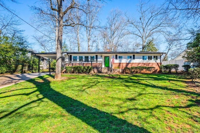 view of front facade featuring a front lawn and a carport