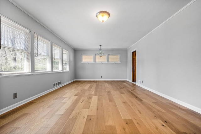 unfurnished room with light hardwood / wood-style floors and crown molding