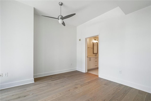 empty room featuring baseboards, light wood-style flooring, and a ceiling fan