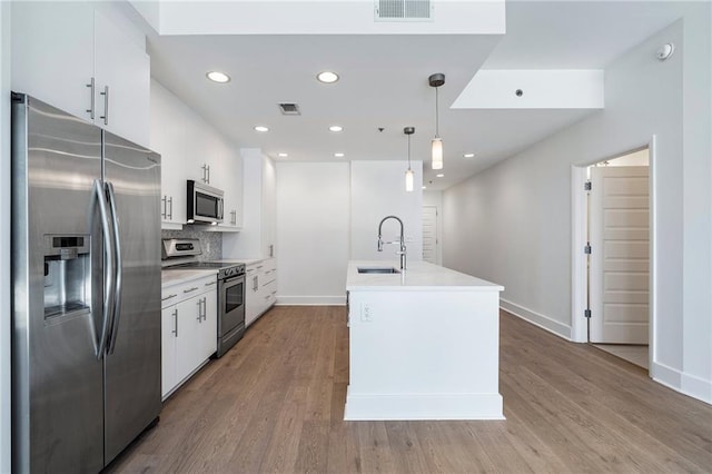 kitchen featuring white cabinetry, a sink, appliances with stainless steel finishes, and visible vents