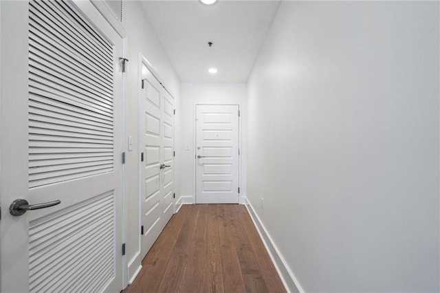 hall with recessed lighting, baseboards, and dark wood finished floors