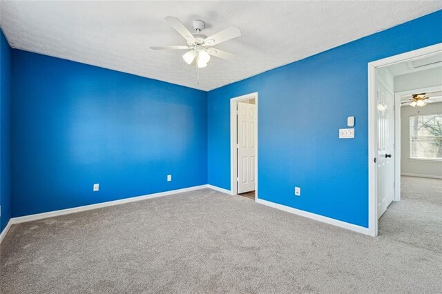 unfurnished bedroom featuring a textured ceiling, carpet floors, and ceiling fan