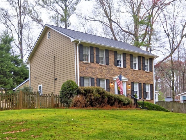 colonial inspired home with a front lawn