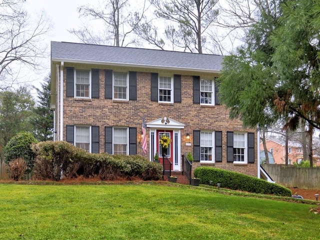 colonial-style house with a front lawn