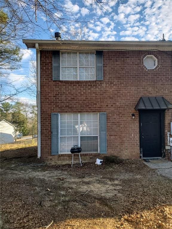 rear view of house with brick siding