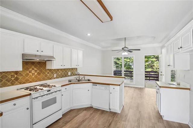 kitchen with white cabinetry, a sink, a peninsula, white appliances, and under cabinet range hood