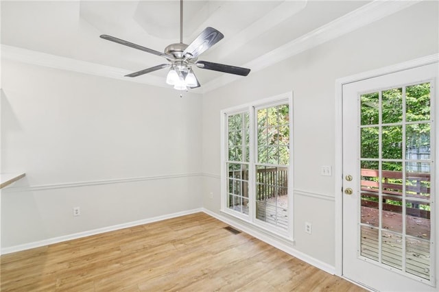 unfurnished room with ceiling fan, ornamental molding, light wood-type flooring, and baseboards