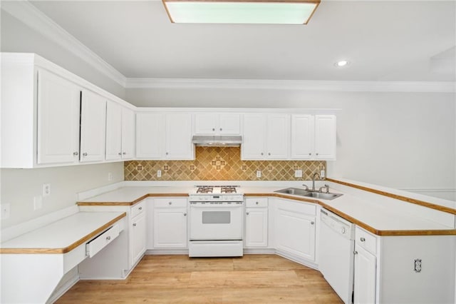 kitchen with under cabinet range hood, a peninsula, white appliances, a sink, and ornamental molding