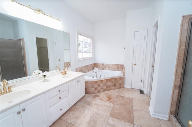 full bath featuring a garden tub, a sink, and a shower stall