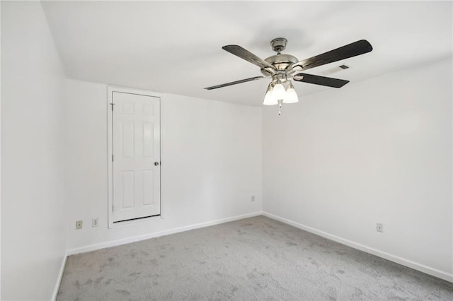 spare room with visible vents, baseboards, and carpet flooring